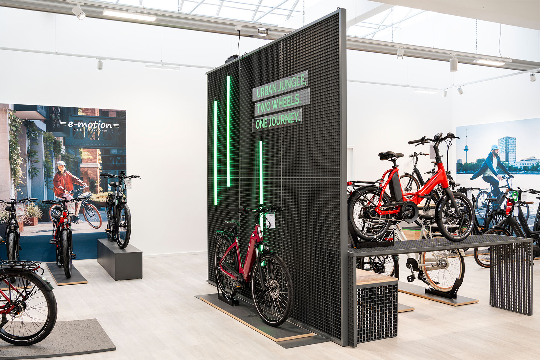 Dark information pillar with "Urban Jungle" neon signage set among the bike displays