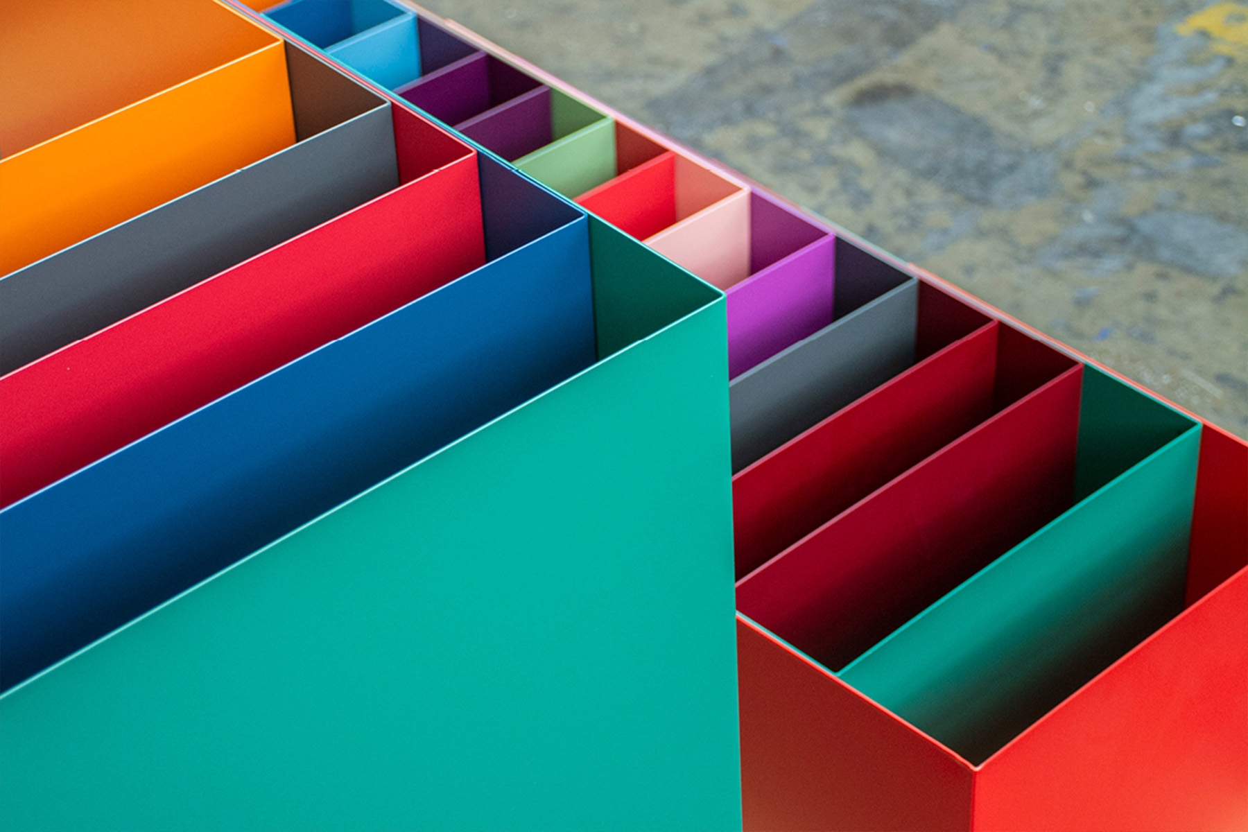 Detail of the color-coded metal elements from the Hugendubel wayfinding system in various signal colors.