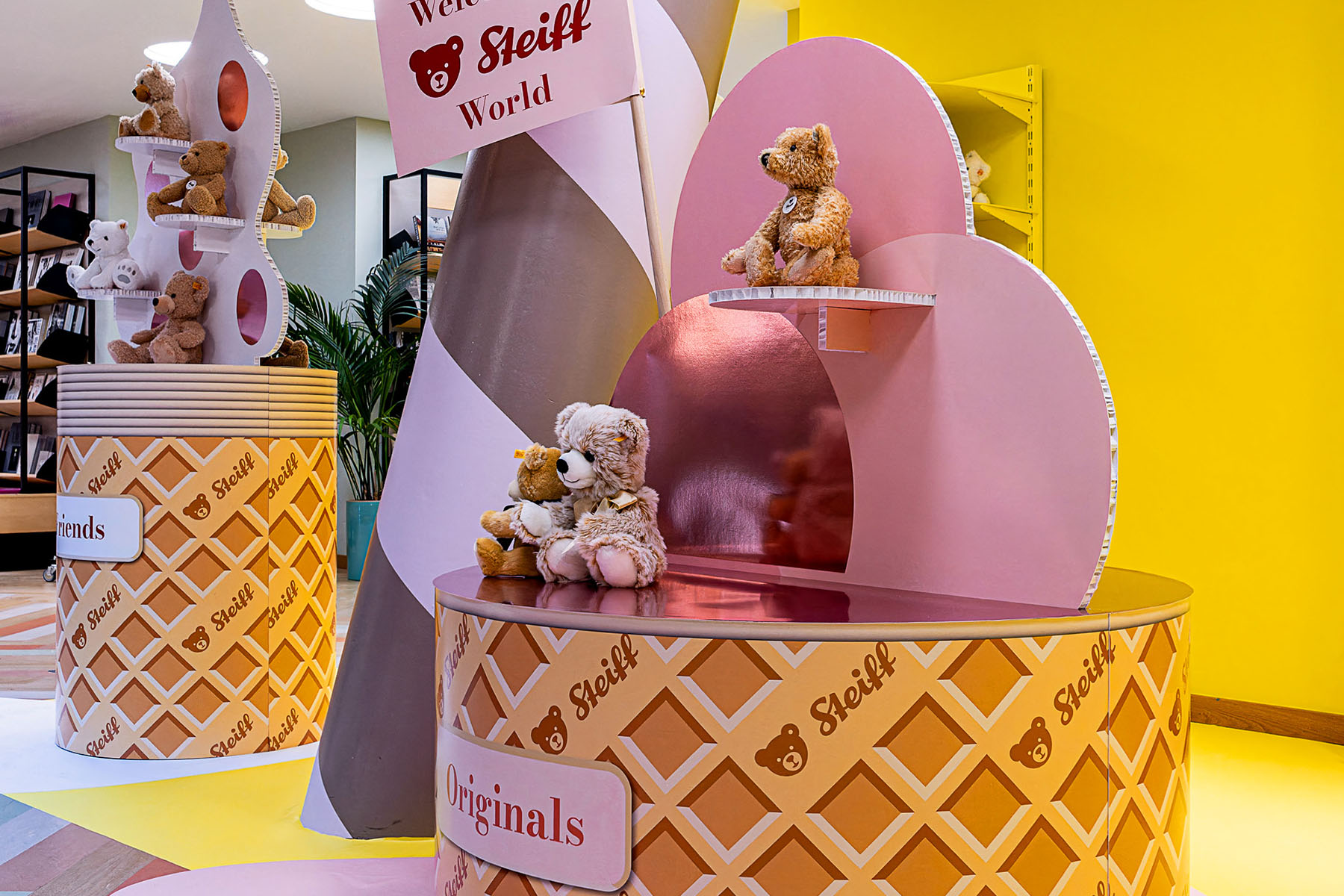 Pinke Regalformen mit Teddybären auf Waffelmuster-Podesten „Friends“ und „Originals“ im Steiff-Pop-up