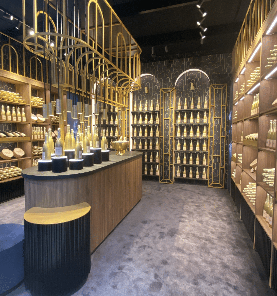 A champagne boutique with gold arch fixtures and bottle displays at EuroShop.