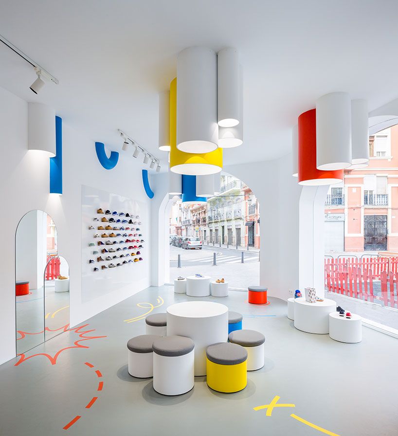 Bunte Ladeninnenarchitektur des Little-Stories-Stores mit Torbögen und Straßenblick
