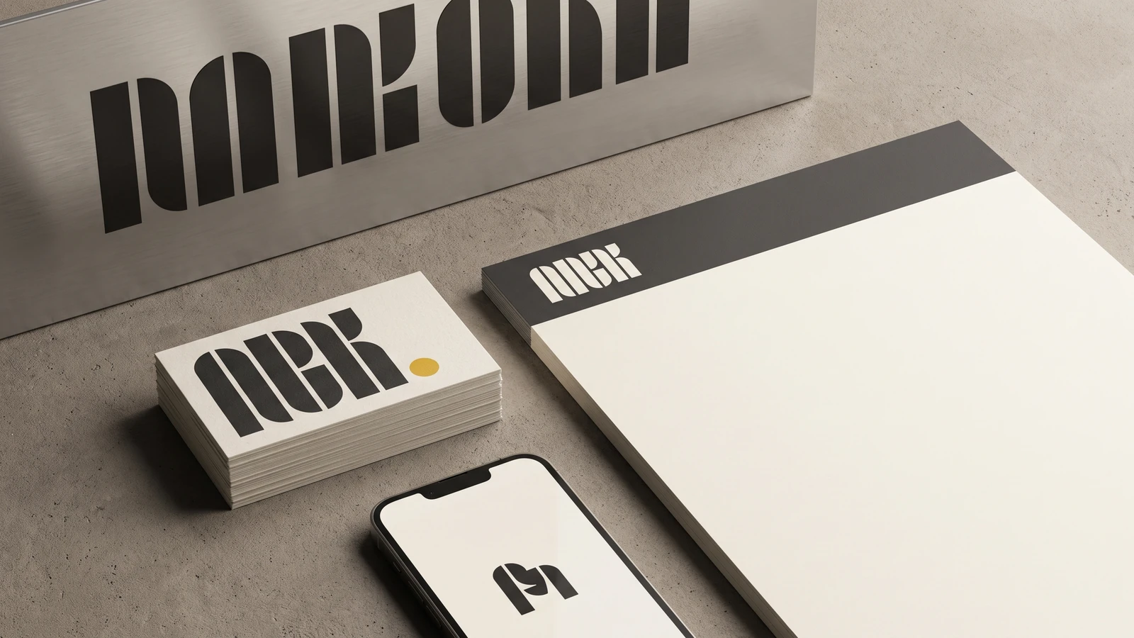 Typography-led identity branding trend example: a wordmark-only brand system across business cards, signage and app icon with a custom typeface