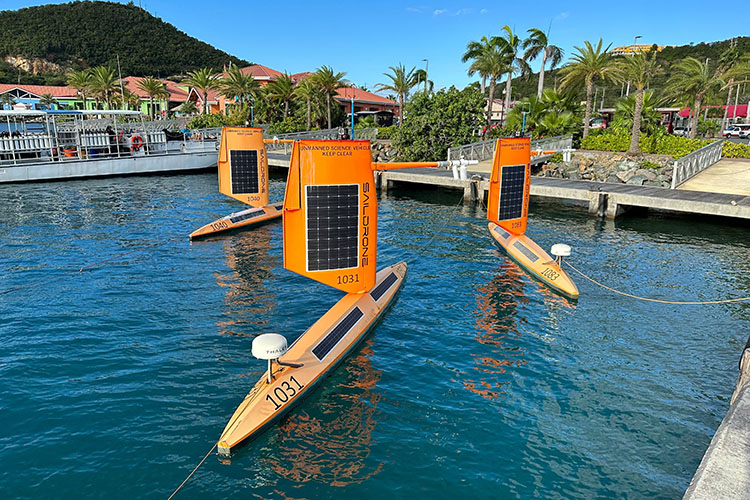 Three Saildrone Explorers at a dock in sunny St. Thomas