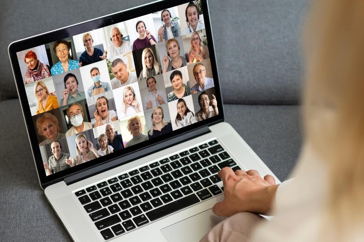  A person viewing different people on a laptop.