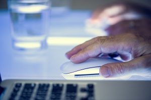 A person using a mouse to interact with online content.