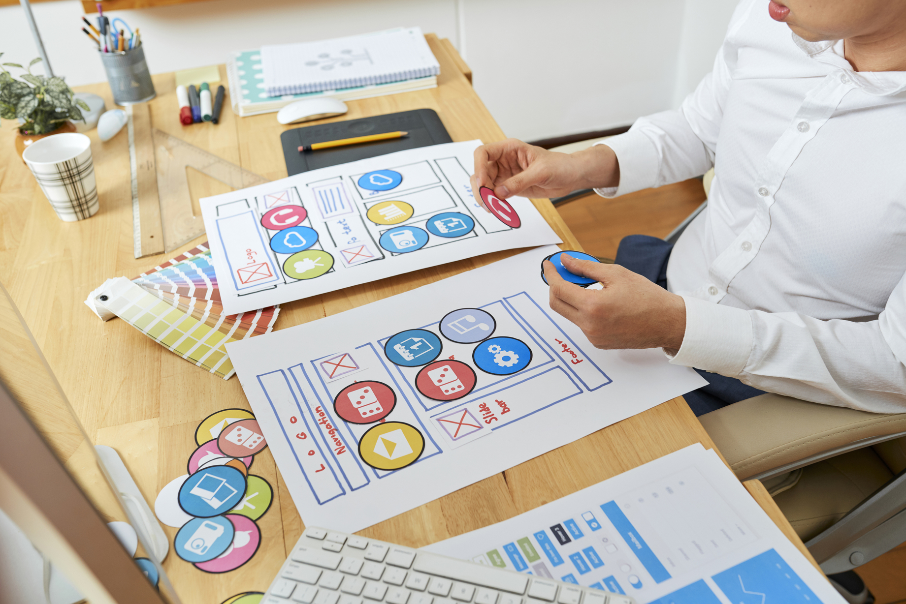 A designer working on various elements.