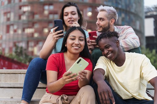A group of people sharing web stories on mobile devices.