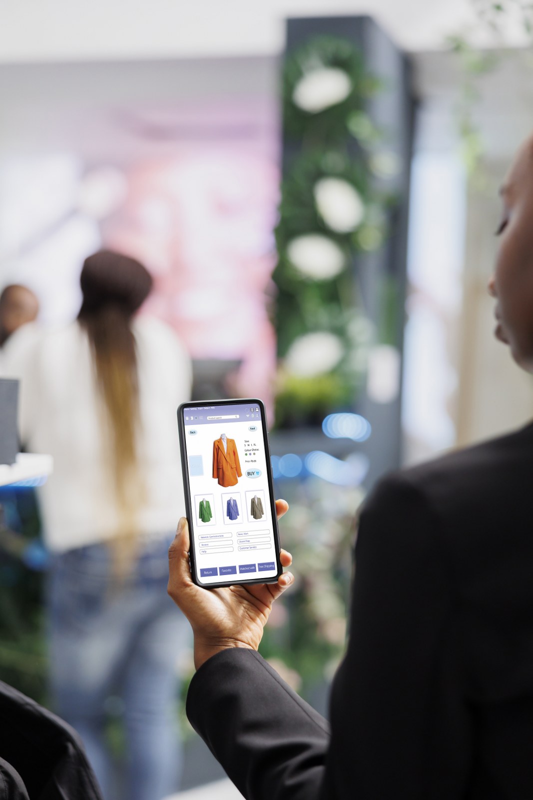 A person making a choice between three jackets while shopping on their phone, showing the value of effective interactive stories.