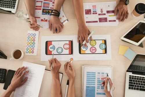 A group of people working on an app.