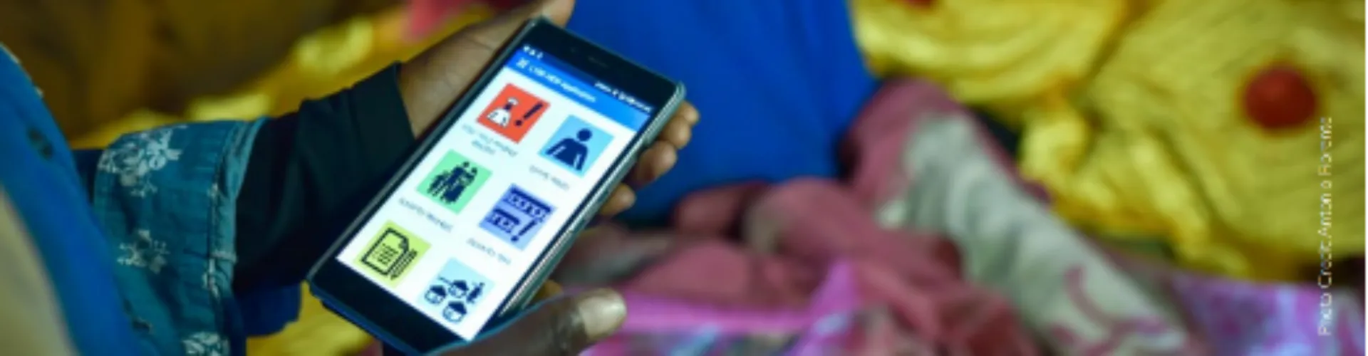 Photo of a community health worker using the eCHIS digital app to help enhance healthcare services in Ethiopia.