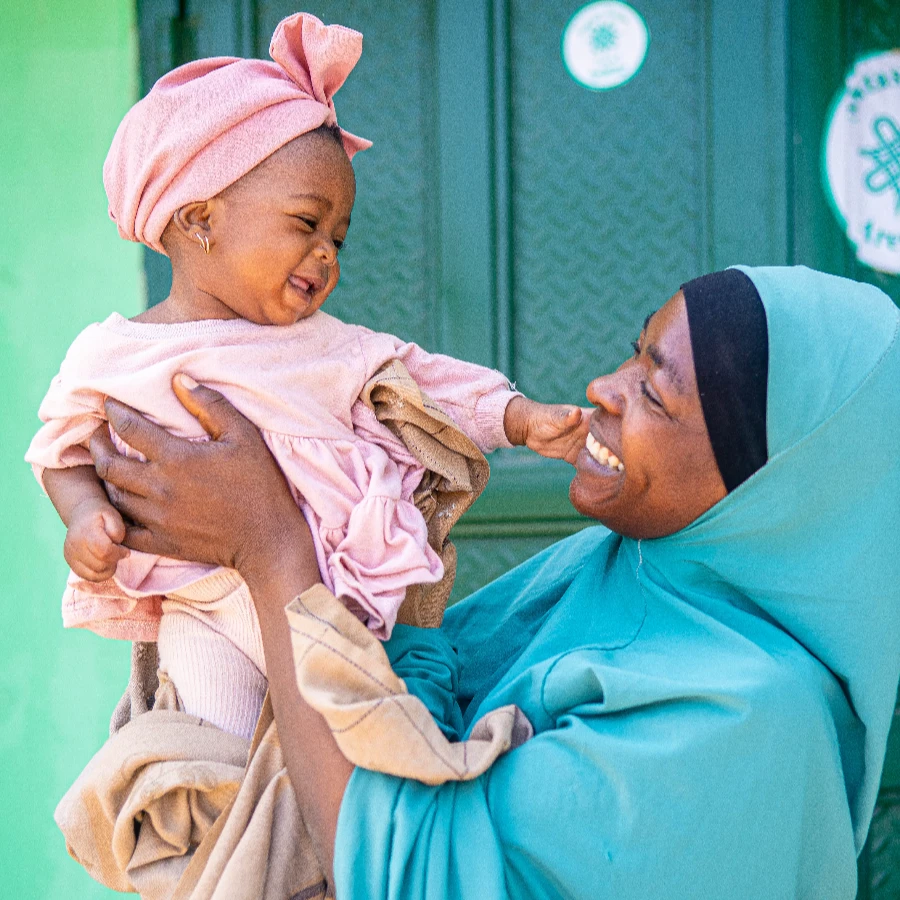 Photo of a young girl being carried by her mother, at Myetti Allah PHC, in Kaduna State, Northern Nigeria in 2025 - as part of the UNICEF-led Child Nutrition Fund, of which CIFF is an anchor investor.