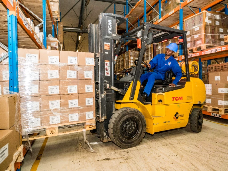 Photo of factory worker loading pallets of lenacapavir.