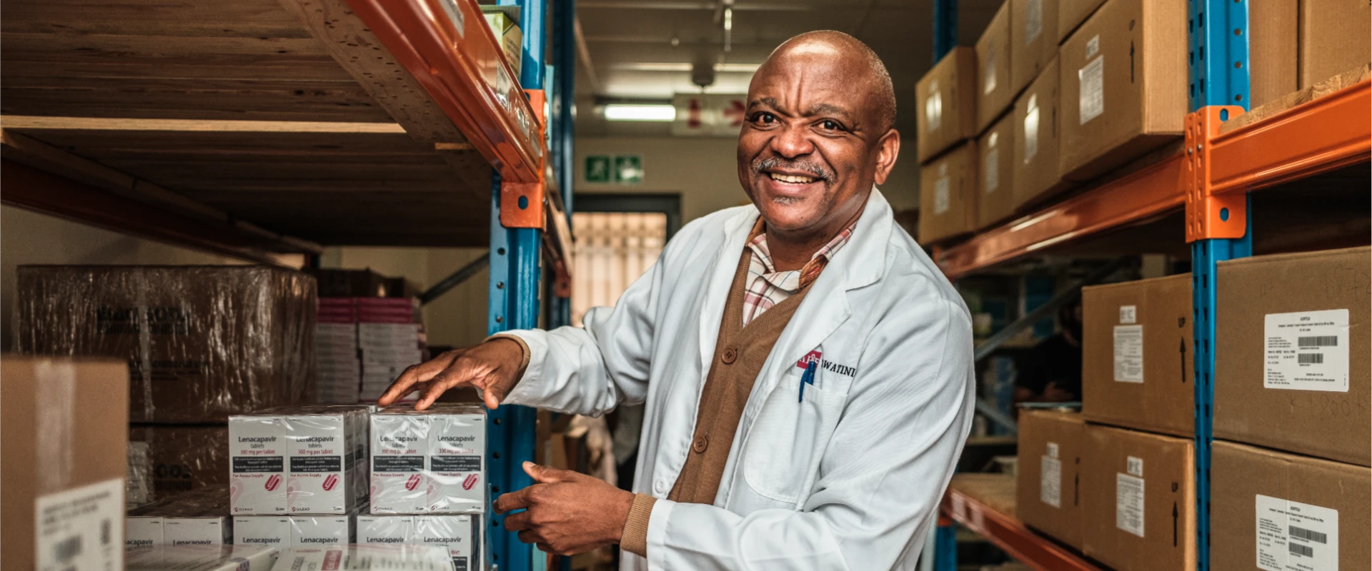 Photo of a pharmacist in a factory unpacking generic Lenacapavir, the twice-yearly injectable which is set to protect millions of people in LMICs from HIV.