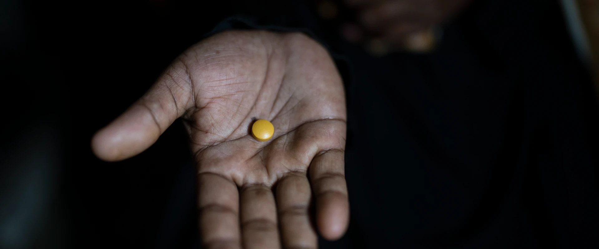 Photo of a woman takes an MMS tablet during her pregnancy to support healthier family well-being.