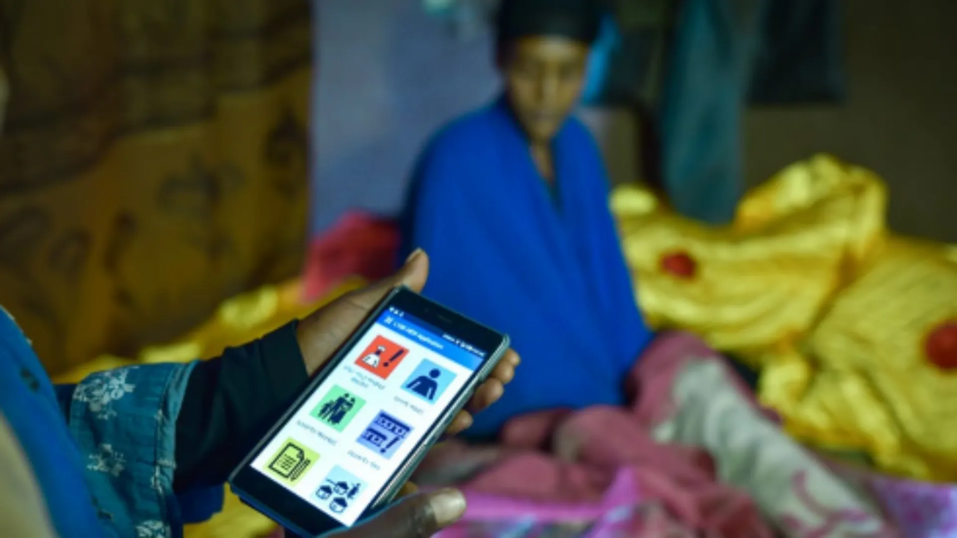 Photo of community health worker using the eCHIS digital app to help enhance healthcare services in Ethiopia.