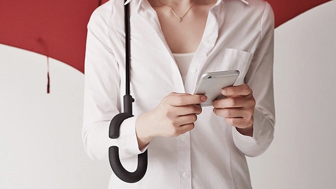 Phonebrella the umbrella has a handle that frees your hands from texting in the rain