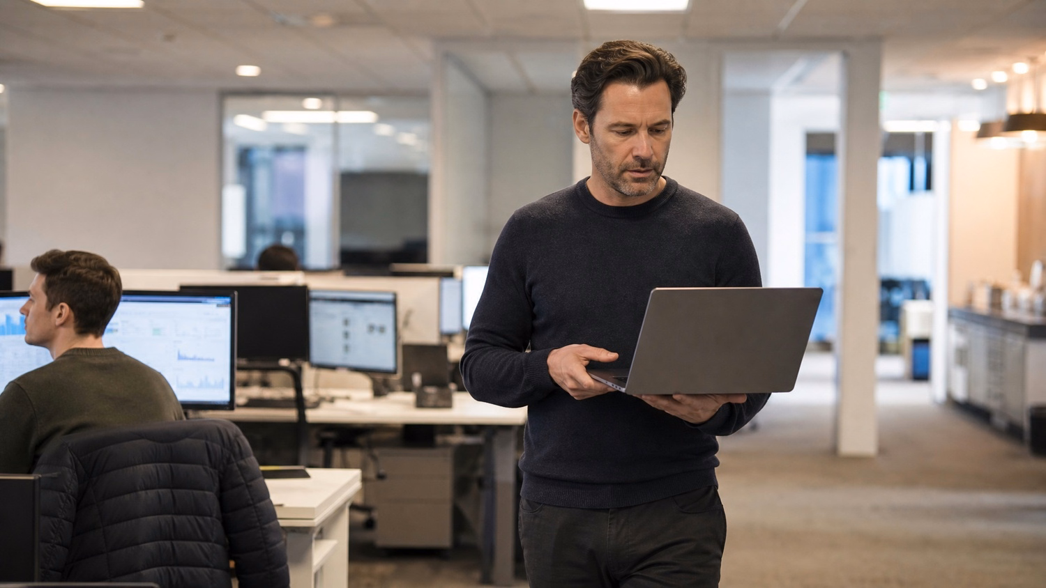 Man reviewing data dashboard on laptop while walking