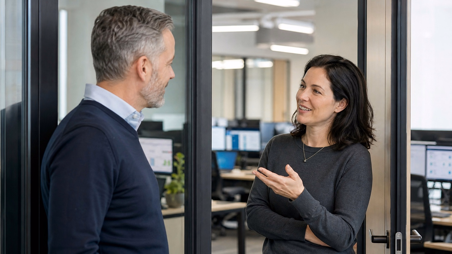 Colleagues discuss digital transformation in office doorway 41