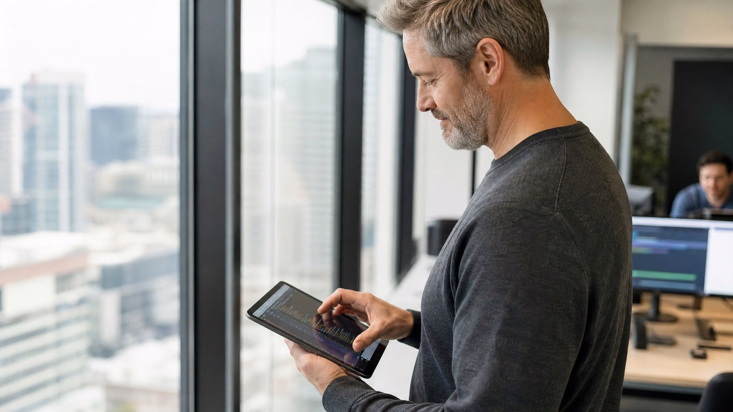 IT consultant reviews code diagnostics on tablet in office