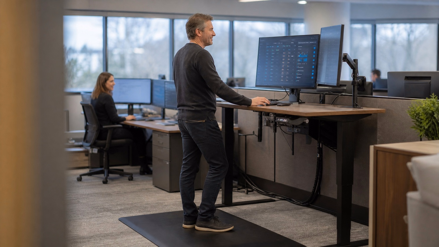 Man reviewing IT dashboard on standing desk 60 chars