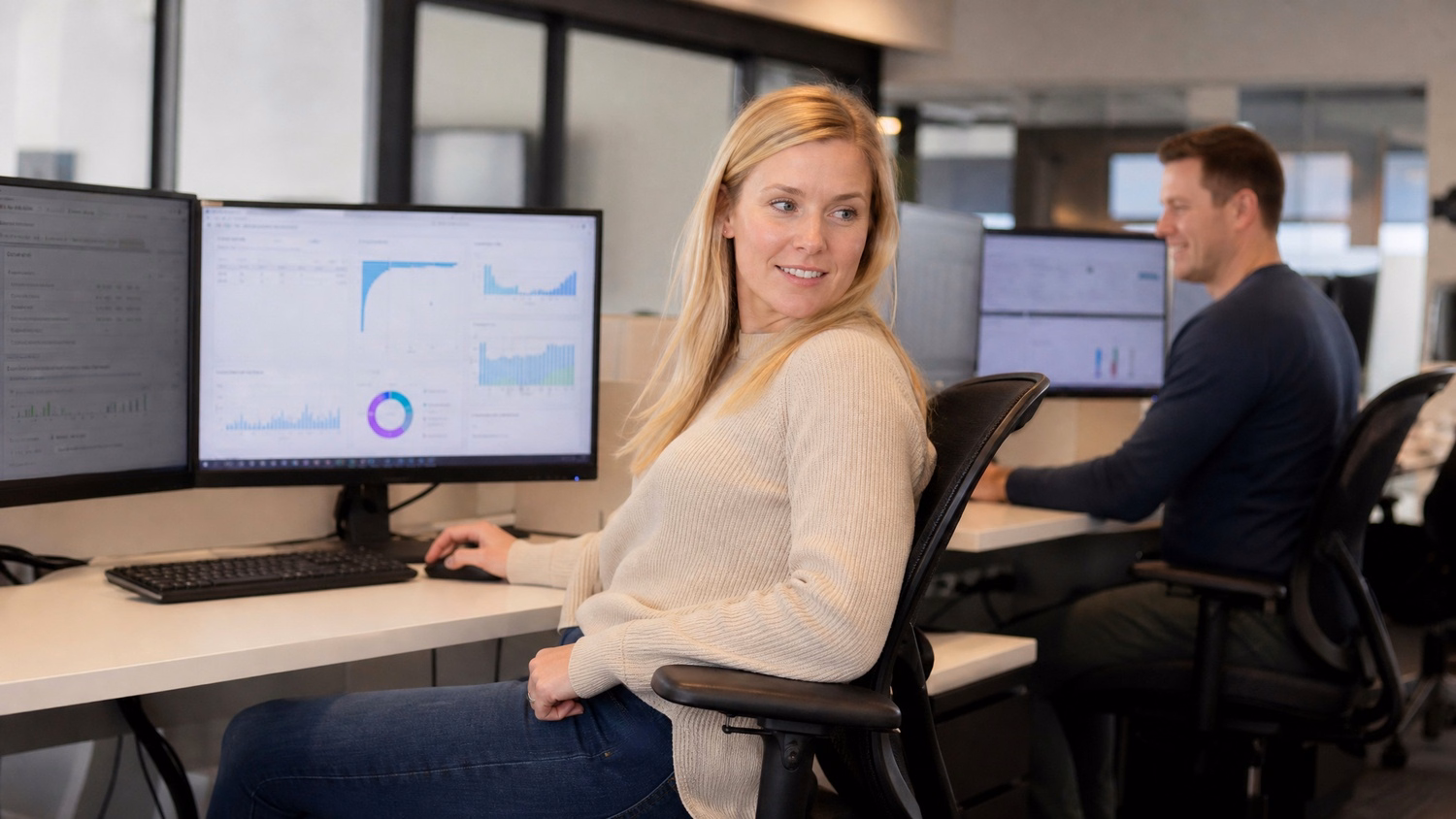 Woman in swivel chair reviews cloud migration reports