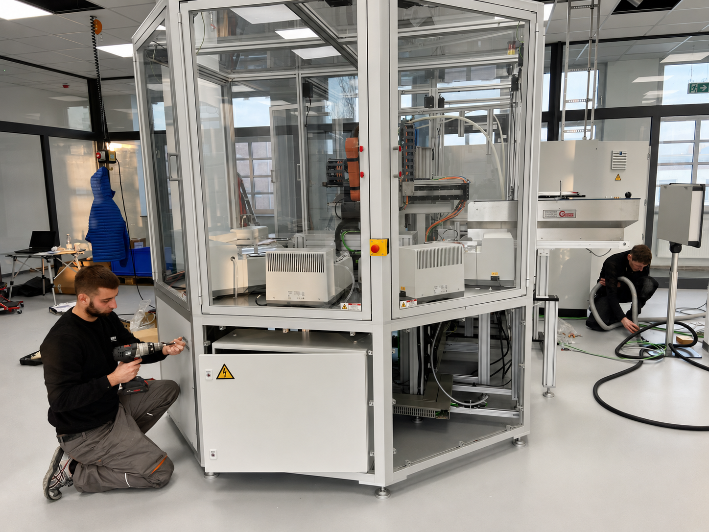 Technician assembling custom production equipment in the workshop
