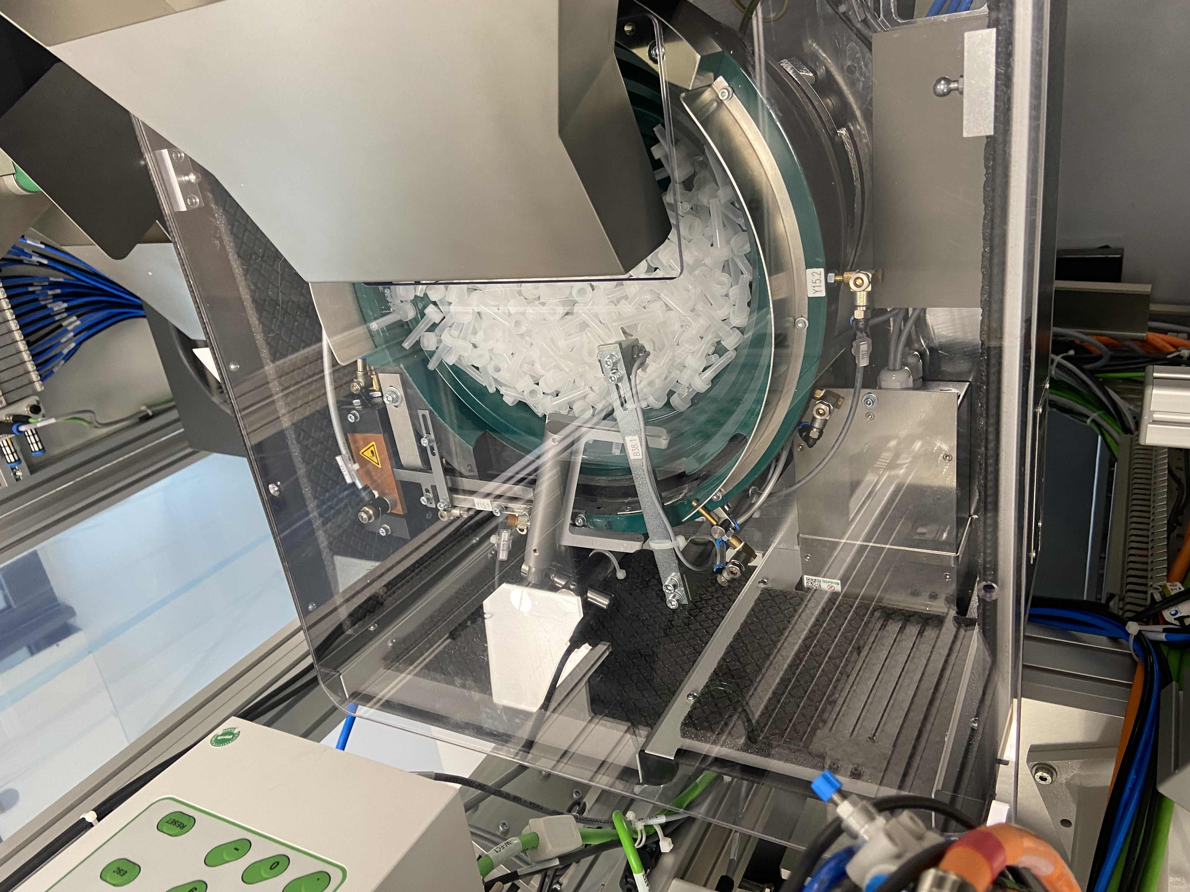 Vibratory bowl feeder supplying small components to the probe-processing machine
