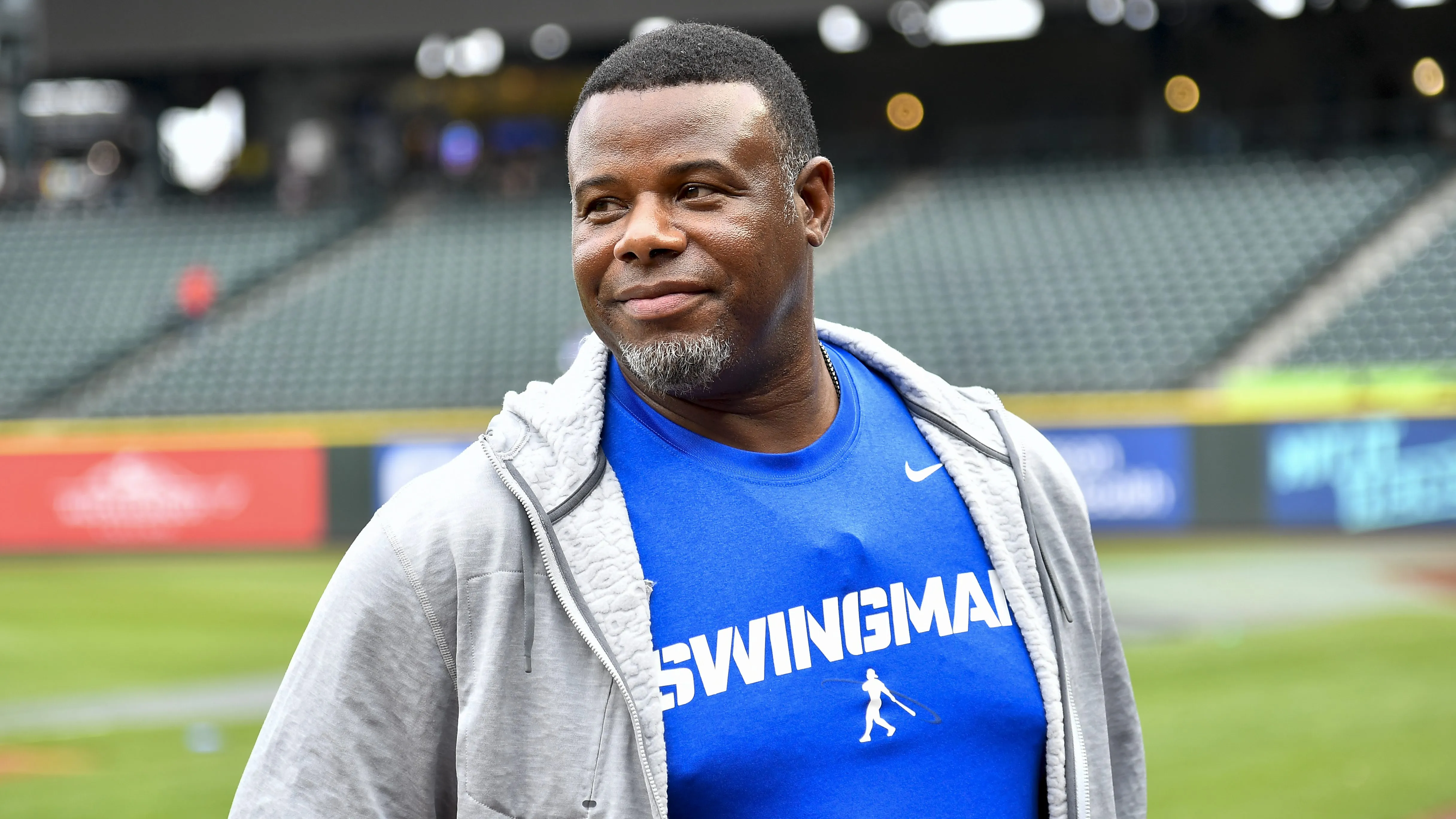 A man wearing a blue shirt with the word swingman on it.