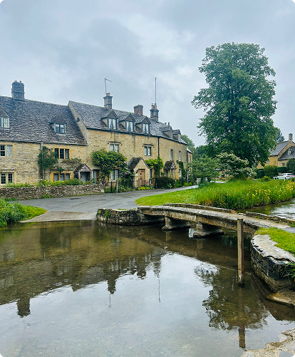 Picturesque village of Lower Slaughter, view of Cottages, with the river and bridge in foreground. 
