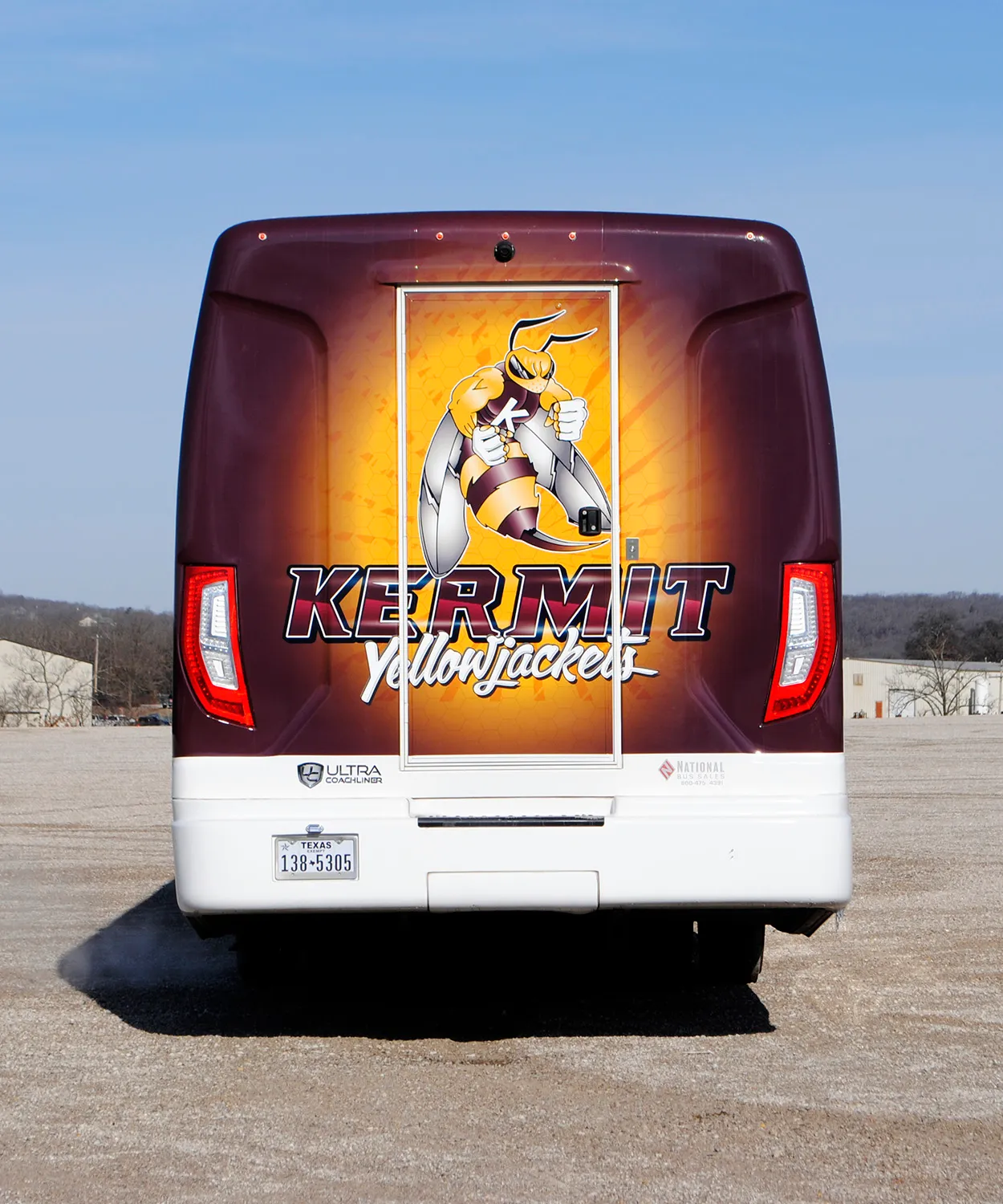 Rear view of a Kermit Yellowjackets Ultra Coachliner wrapped by National Wrap Co.