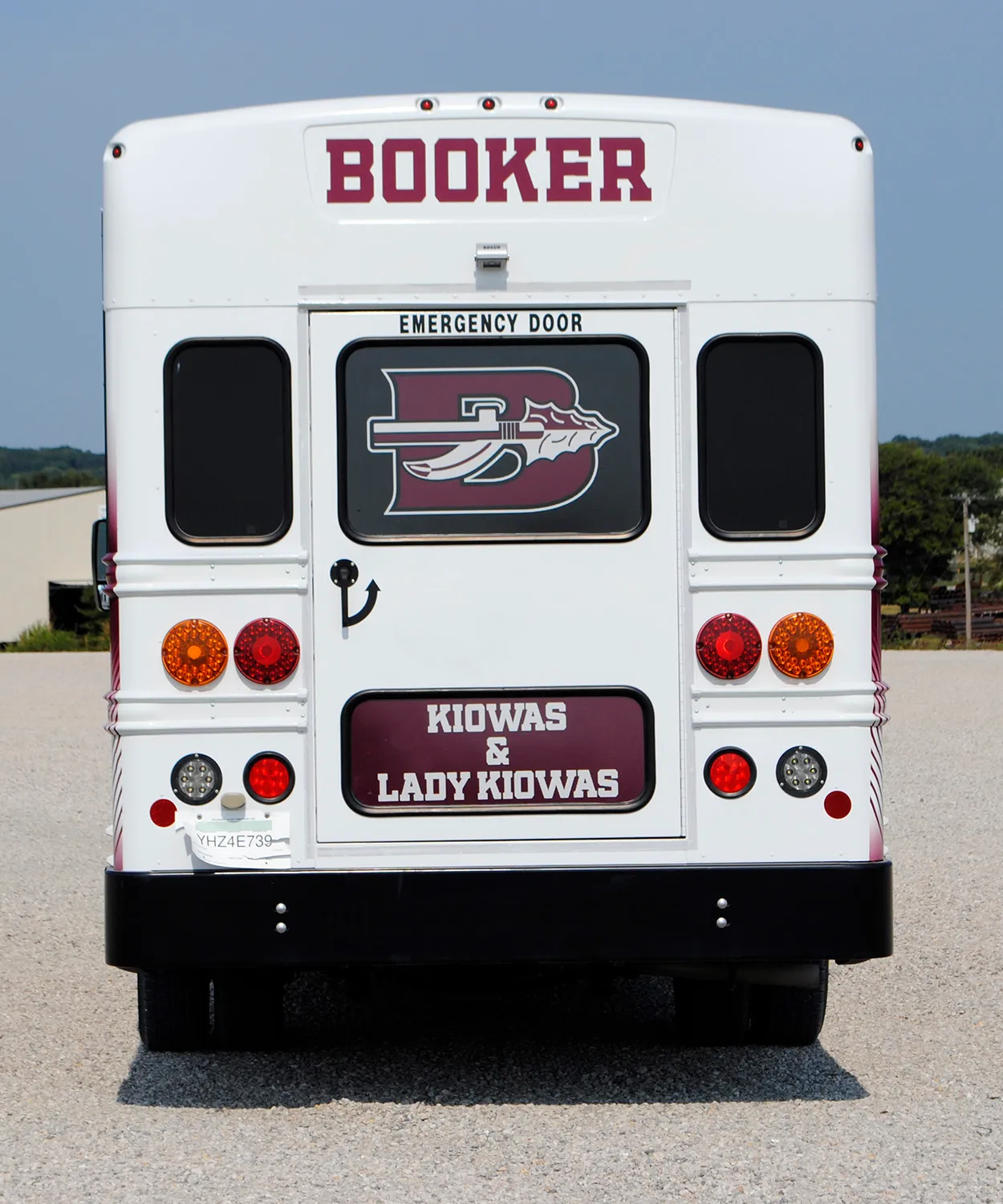Rear view of a Booker Kiowas and Lady Kiowas bus wrapped by National Wrap Co.