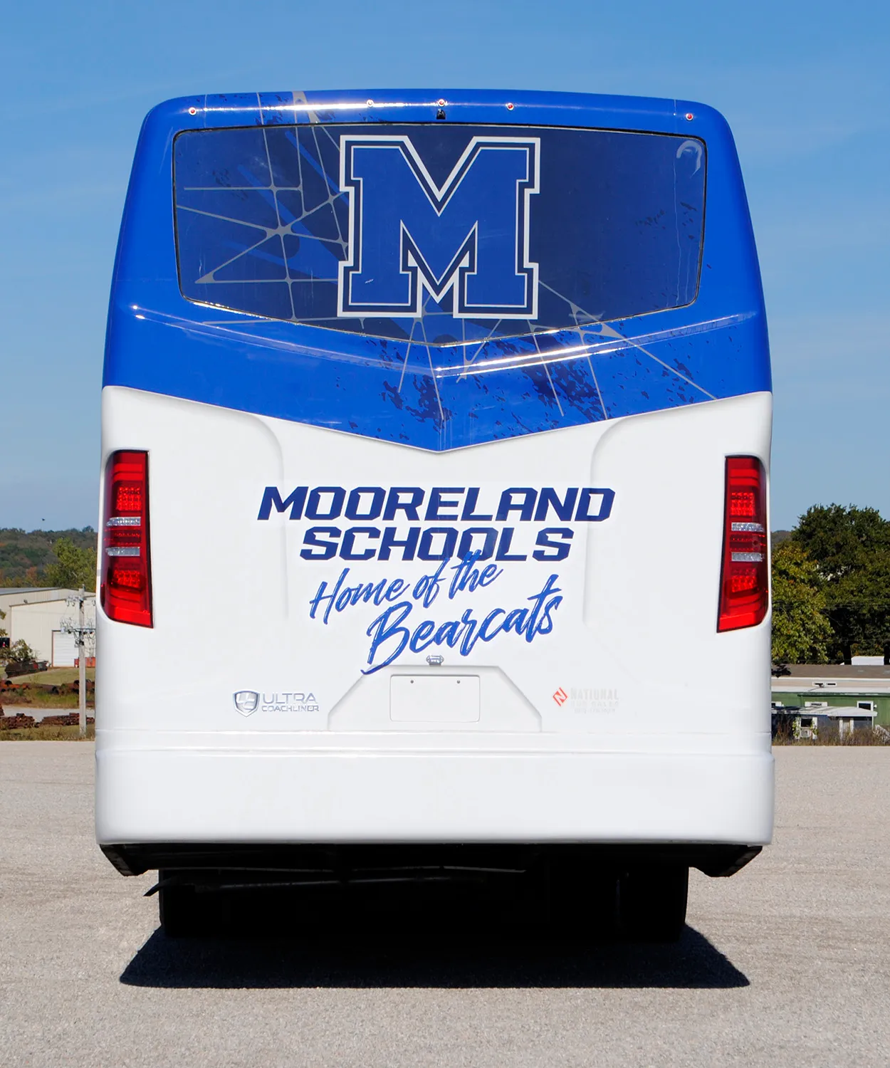 Rear view of a Mooreland Bearcats Ultra Coachliner wrapped by National Wrap Co.
