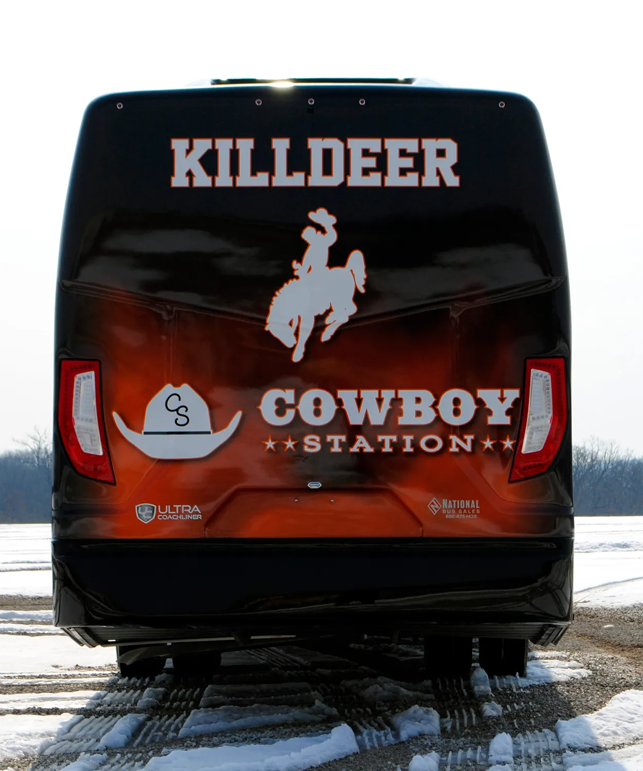 Rear view of a Killdeer Cowboy Ultra Coachliner wrapped by National Wrap Co.