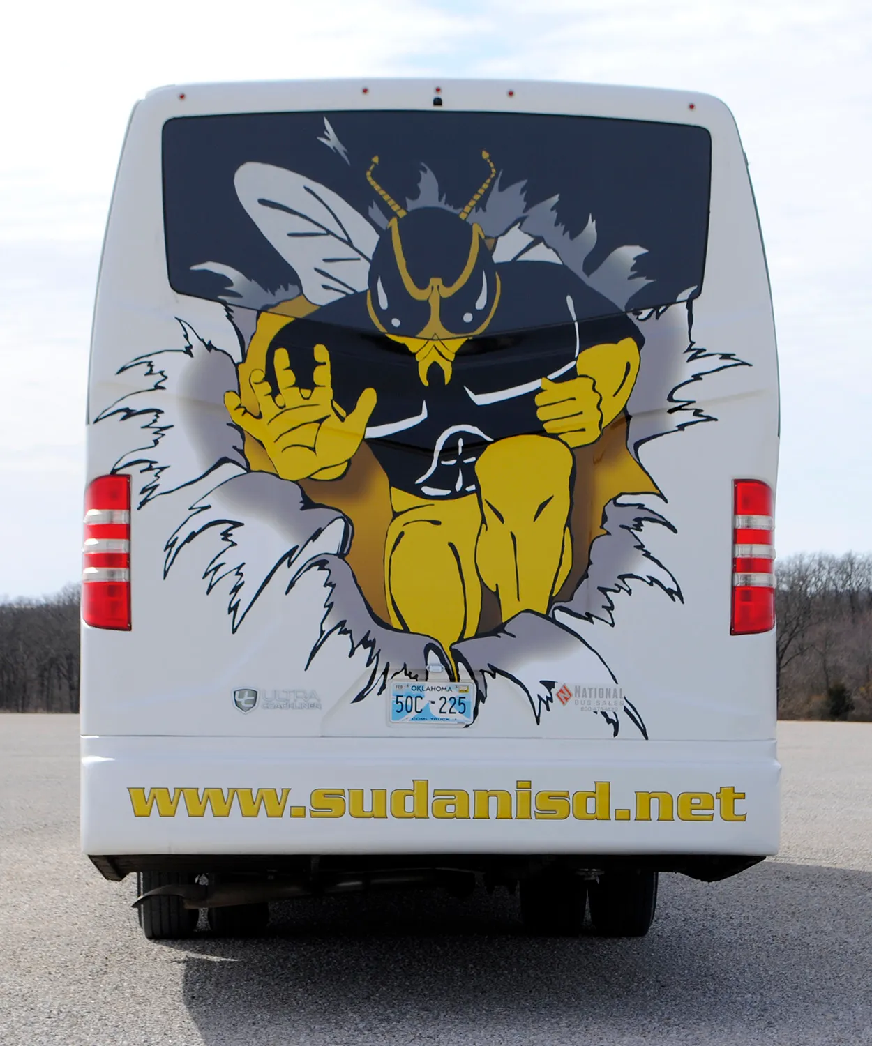 Rear view of a Sudan ISD Ultra Coachliner wrapped by National Wrap Co.