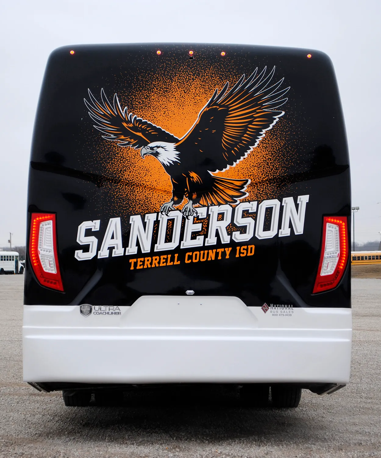 Rear view of a Sanderson Terrell County ISD Ultra Coachliner wrapped by National Wrap Co.