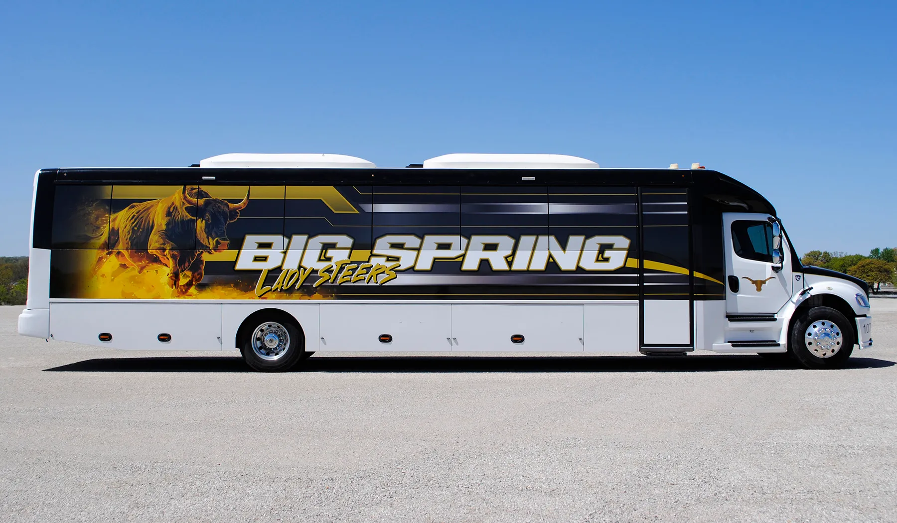 Side view of a Big Spring Lady Steers Ultra Coachliner wrapped by National Wrap Co.