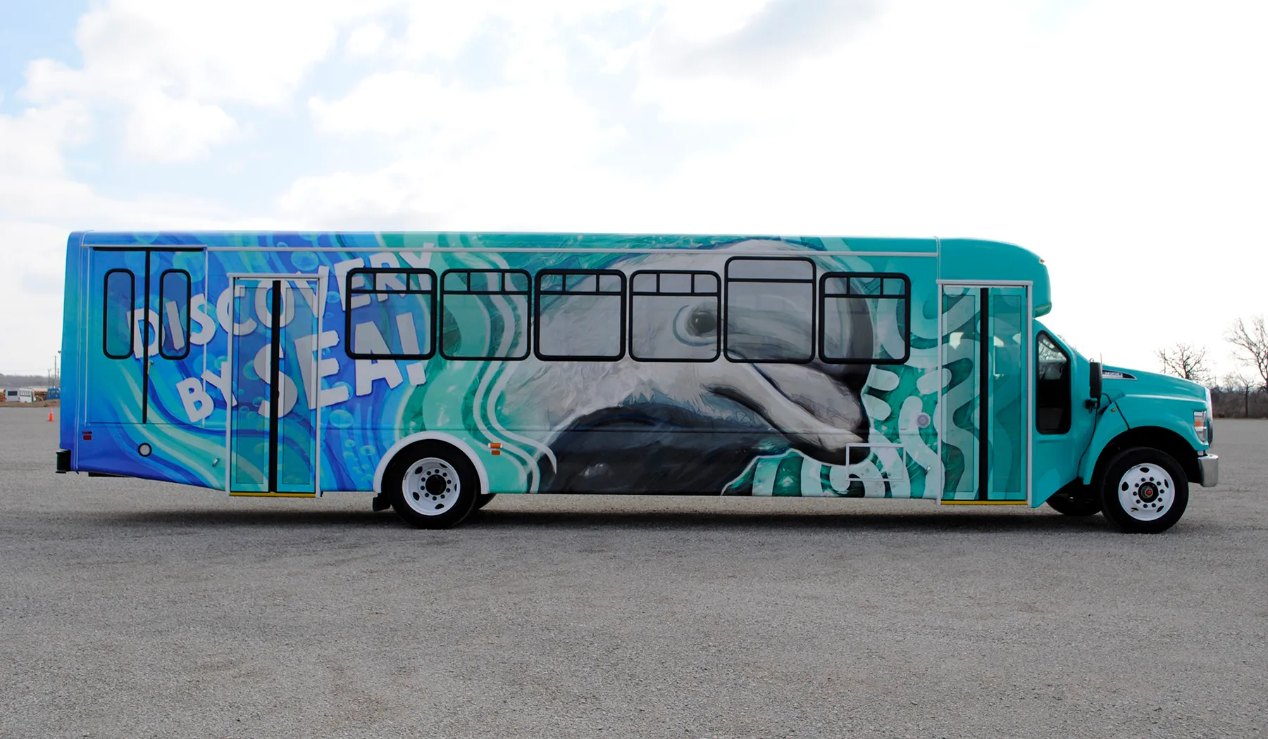 Side view of a Six Flags Discovery By Sea bus wrapped by National Wrap Co.