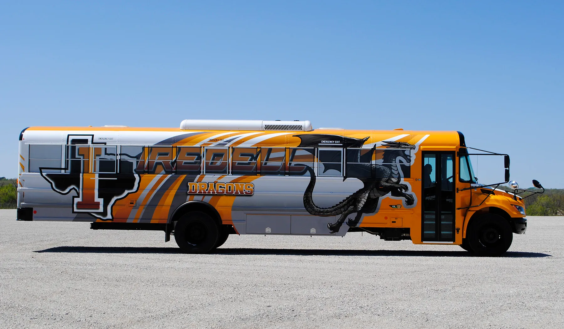 Side view of a Iredell Dragons bus wrapped by National Wrap Co.