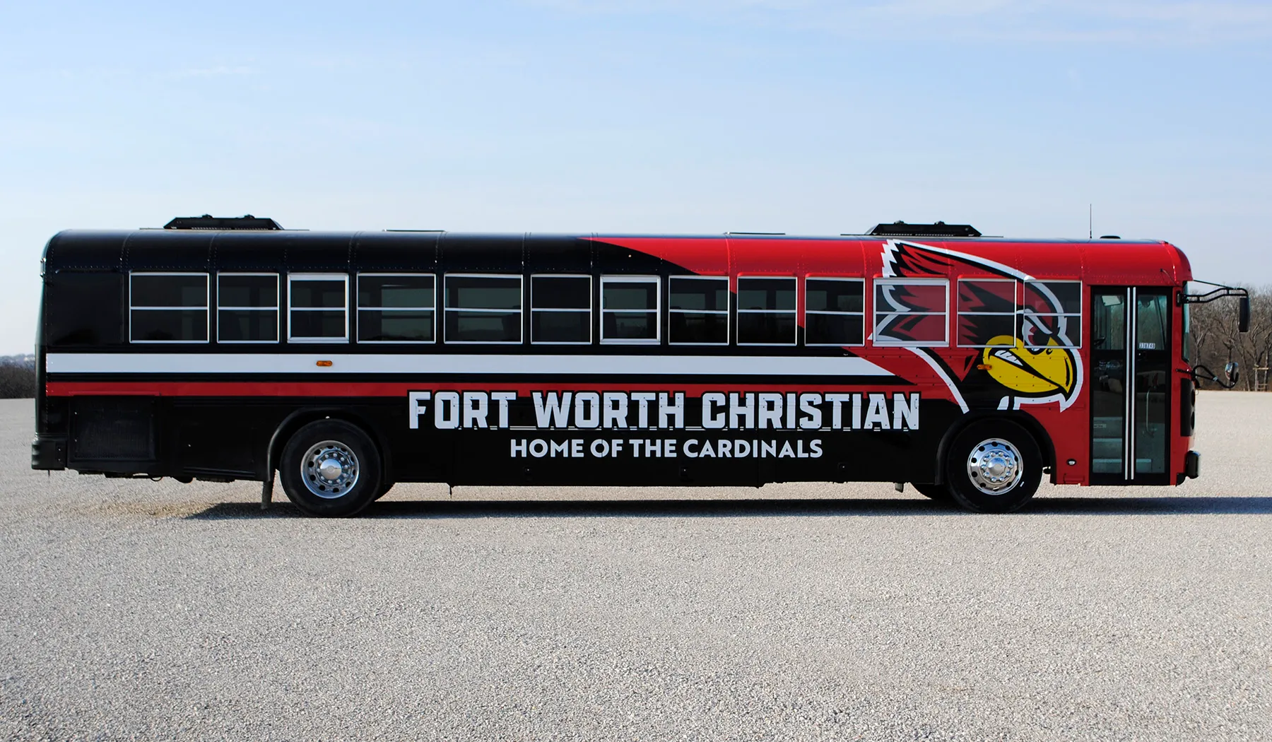 Side view of a Fort Worth Christian Cardinals bus wrapped by National Wrap Co.