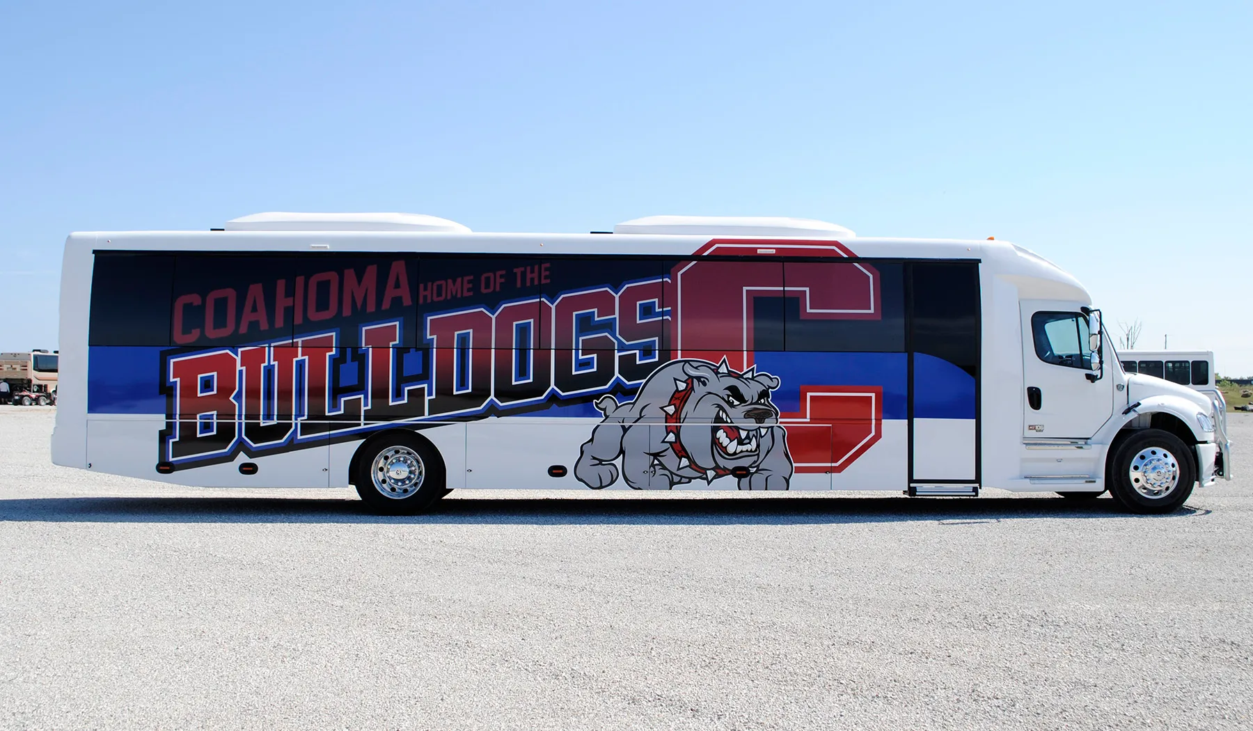 Side view of a Coahoma Bulldogs Ultra Coachliner wrapped by National Wrap Co.