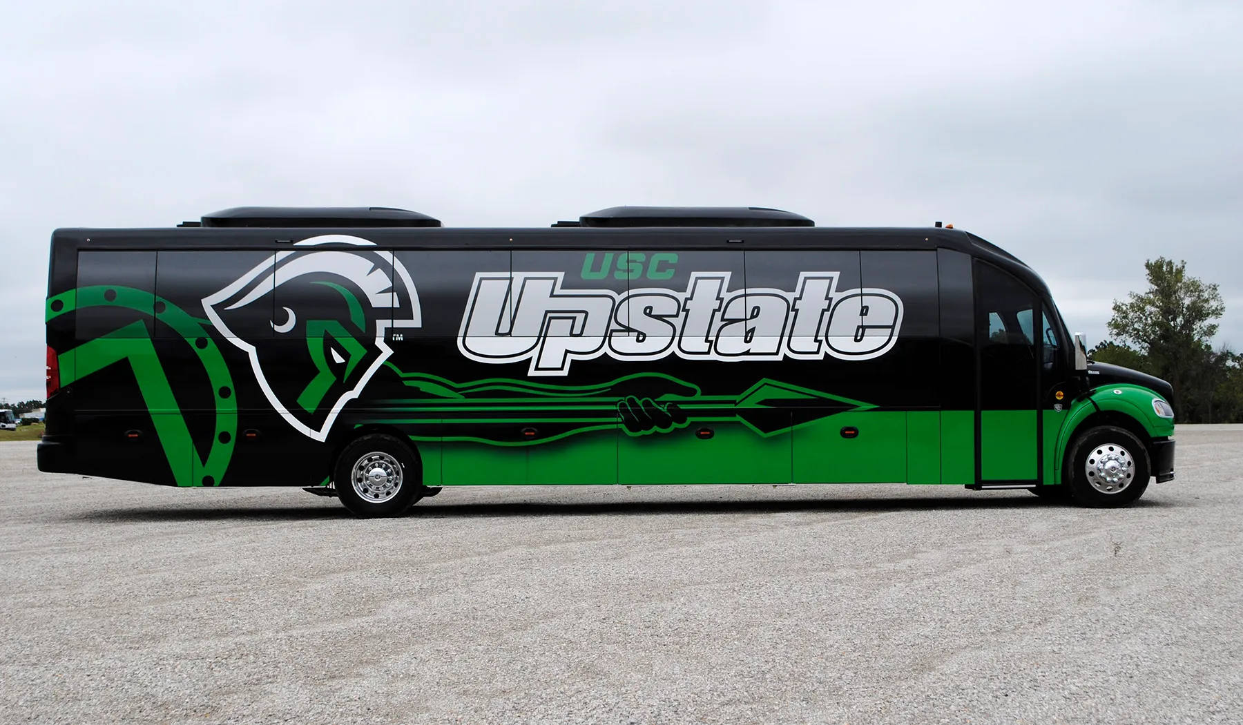 Side view of a USC Upstate Ultra Coachliner wrapped by National Wrap Co.