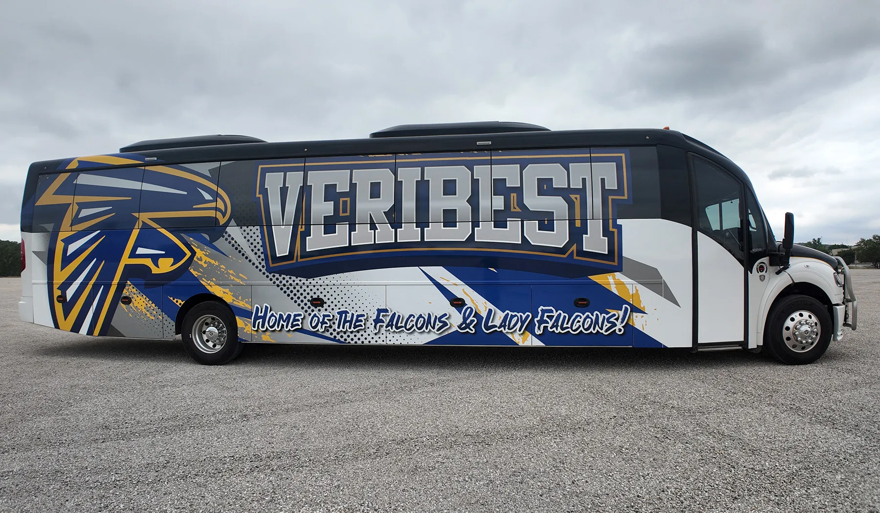 Side view of a Veribest Falcons and Lady Falcons Ultra Coachliner wrapped by National Wrap Co.