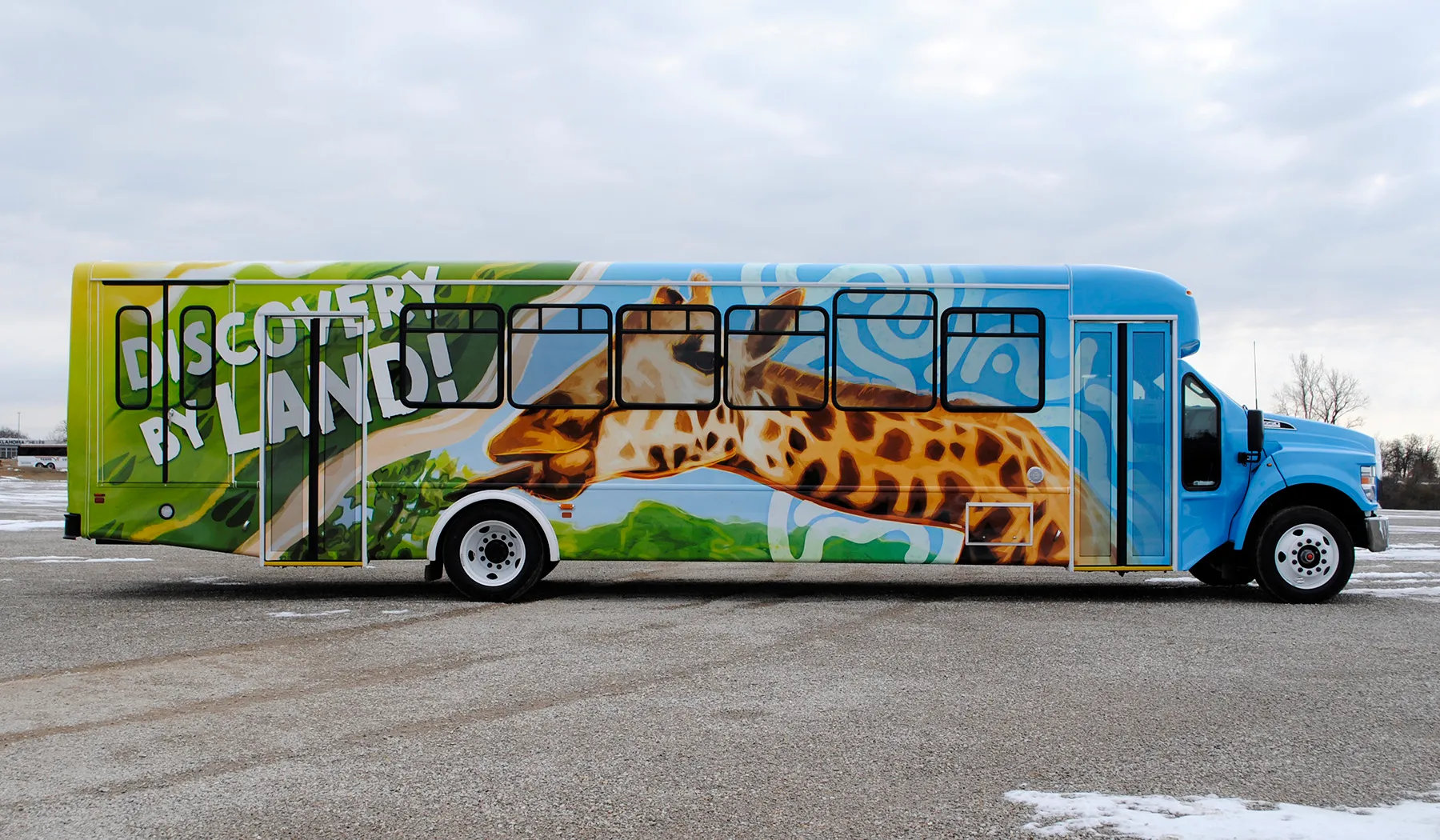 Side view of a Six Flags Discovery by Land bus wrapped by National Wrap Co.
