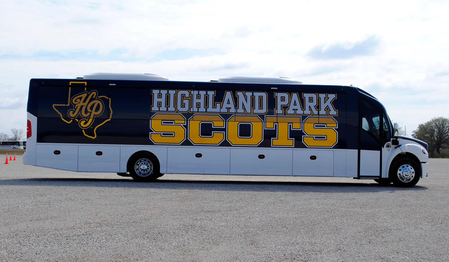 Side view of a Highland Park Scots Ultra Coachliner wrapped by National Wrap Co.
