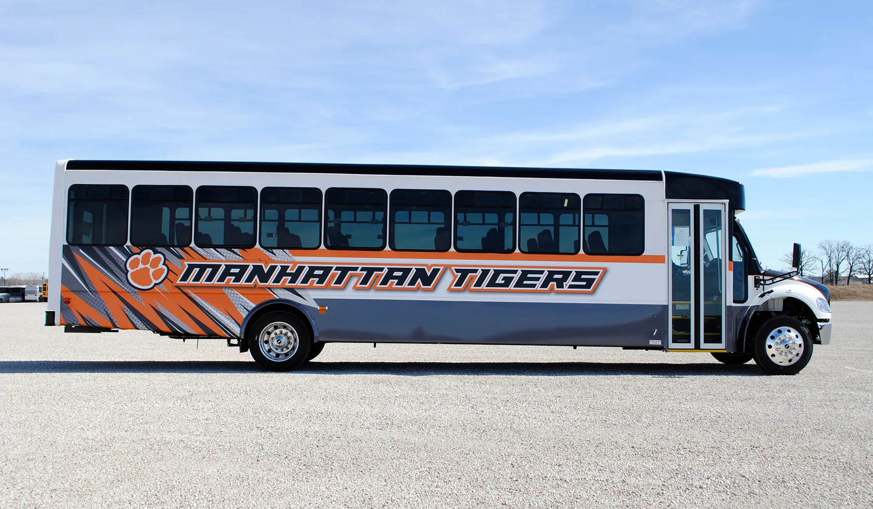 Side view of a Manhattan Tigers bus wrapped by National Wrap Co.
