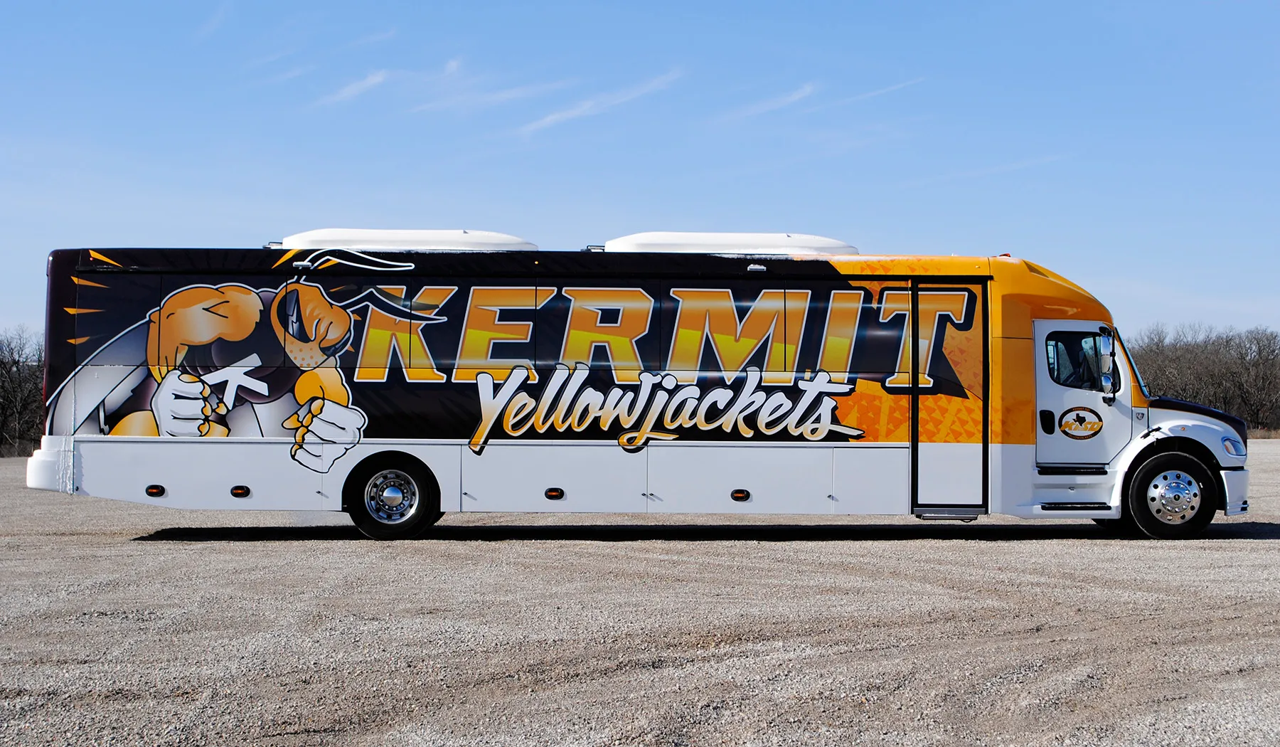 Side view of a Kermit Yellowjackets Ultra Coachliner wrapped by National Wrap Co.
