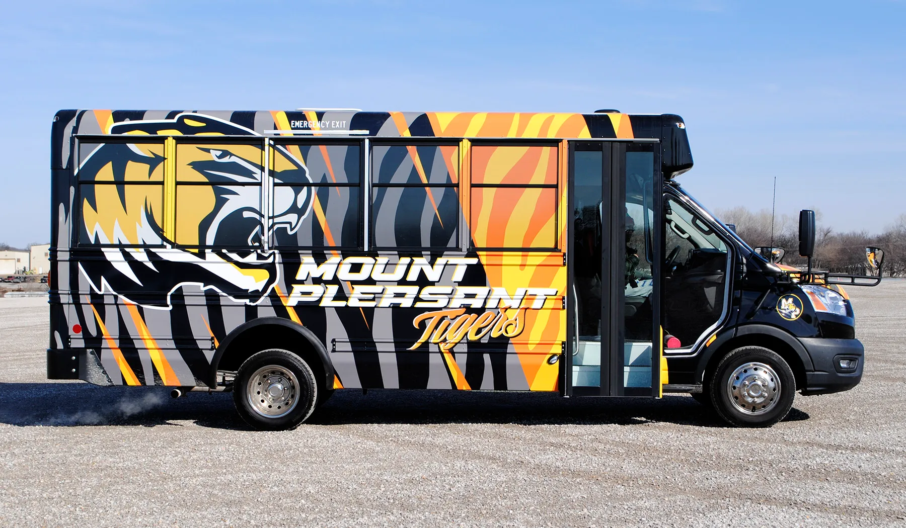 Side view of a Mount Pleasant Tigers shuttle wrapped by National Wrap Co.