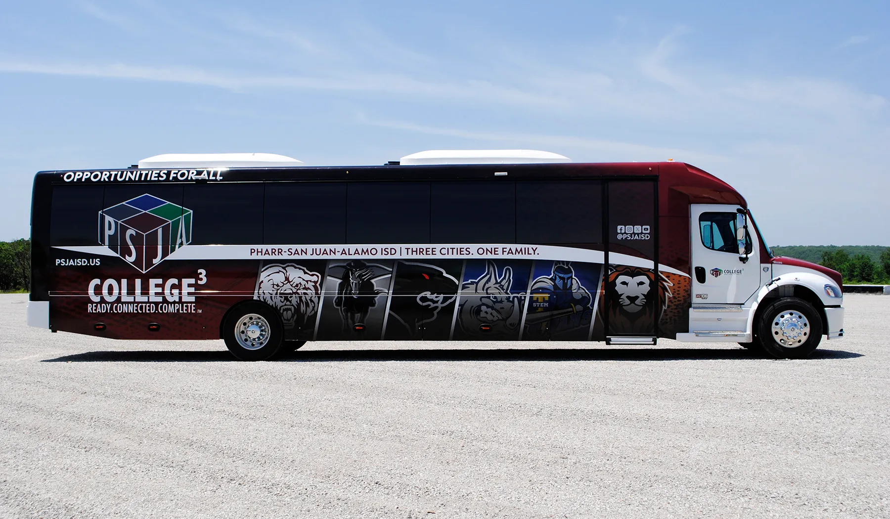 Side view of a Pharr-San Juan-Alamo ISD Ultra Coachliner wrapped by National Wrap Co.