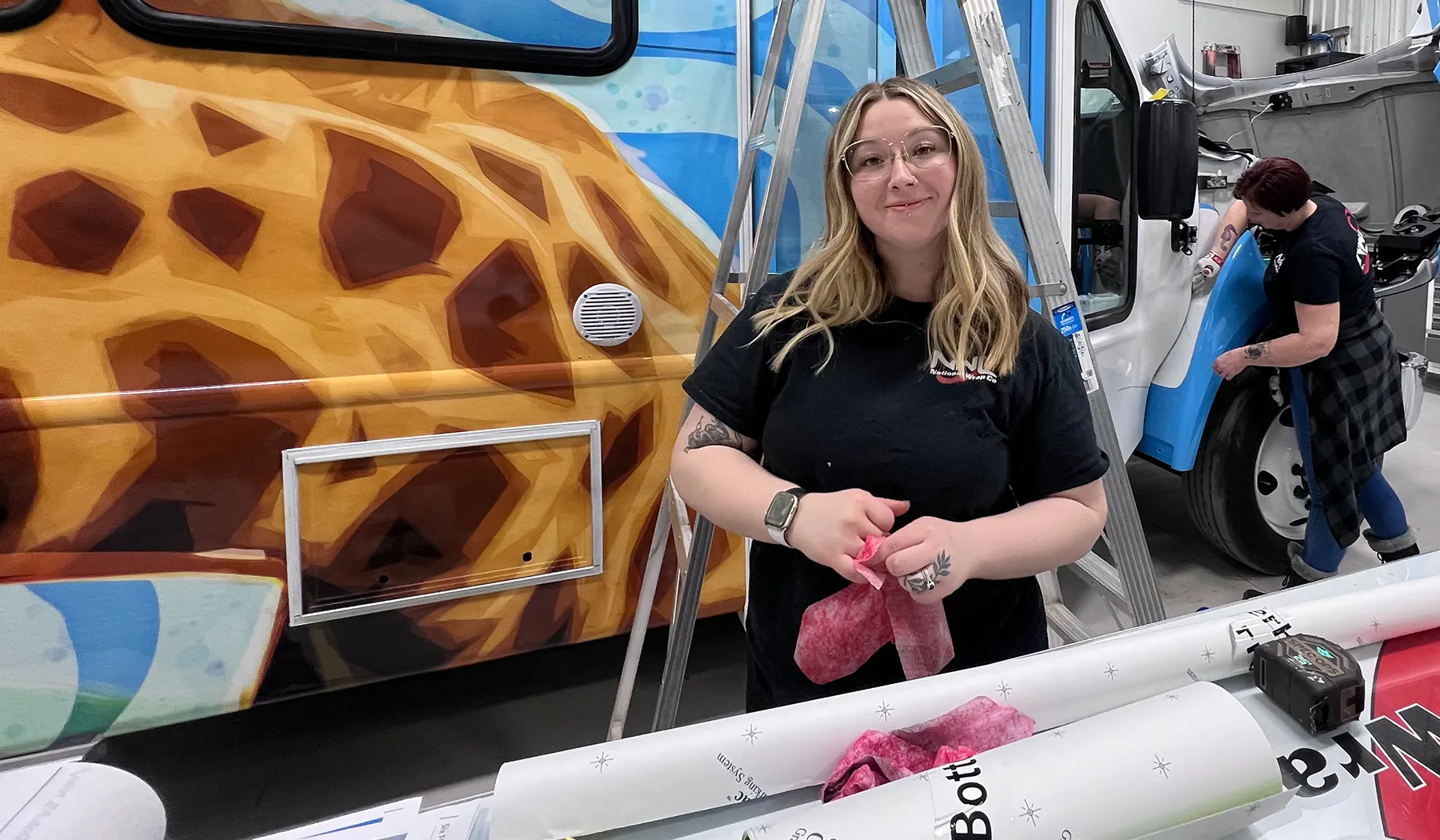 National Wrap Co. installers working on a Six Flags bus.