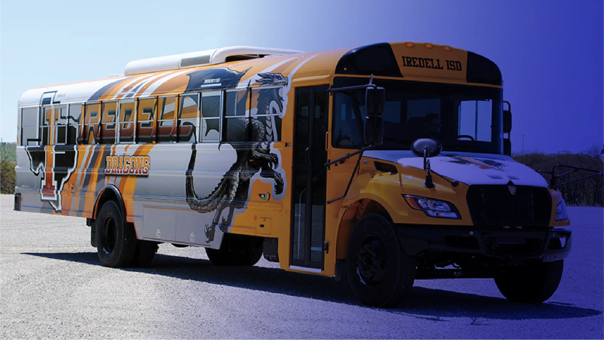 Yellow school bus wrapped in team's branding